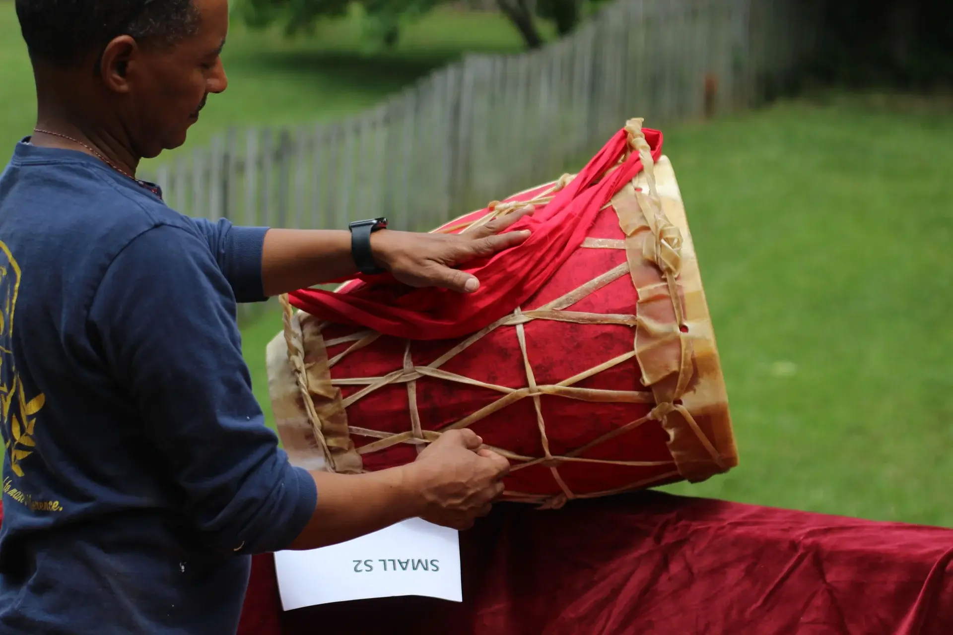 A man who made a red Keboro holding it for show